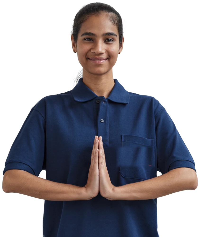 A smiling woman in a navy polo shirt greeting you with folded hands